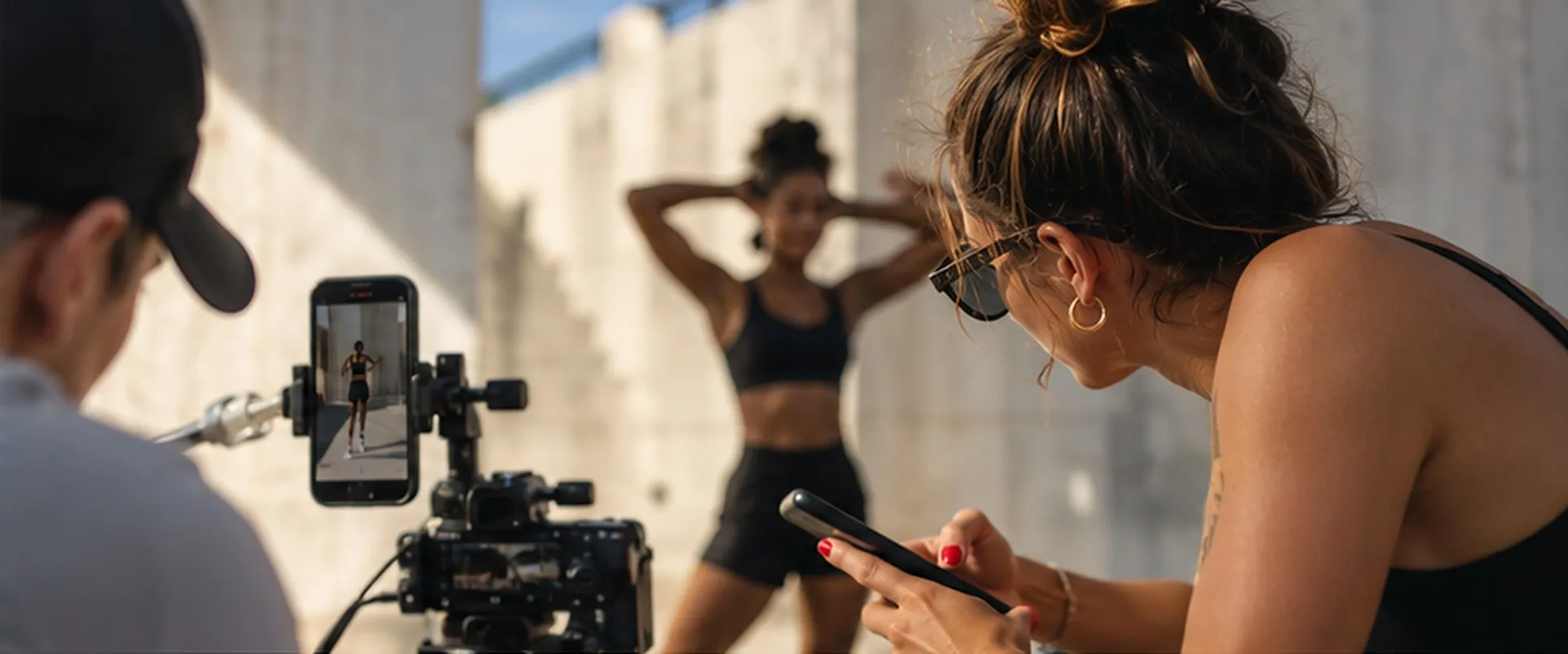 A creator being filmed for a brand campaign against a concrete wall